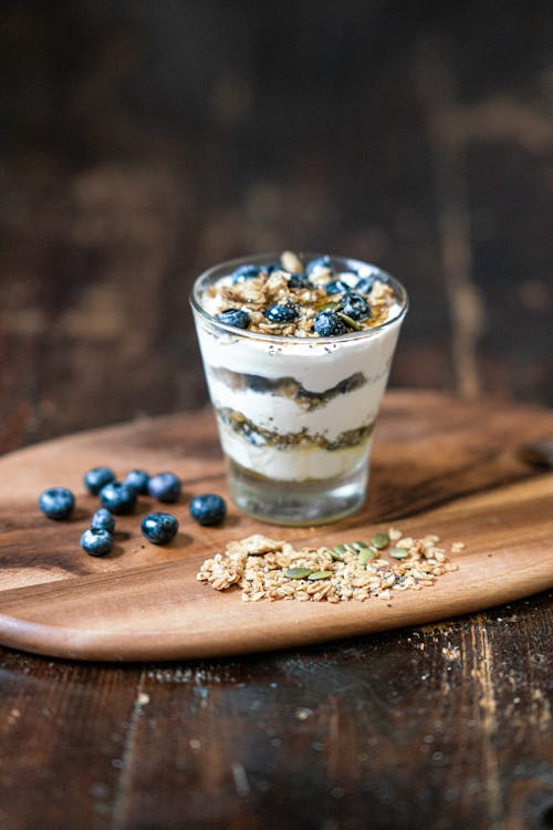 Free A Delicious Blueberry Pudding on Brown Wooden Chopping Board Stock Photo